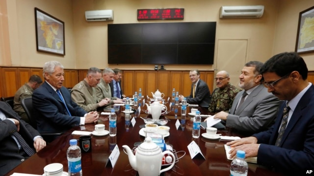 U.S. Secretary of Defense Chuck Hagel, left, meets with Afghanistan's Defense Minister Bismallah Khan Mohammadi, second right, at the ISAF (International Security Assistance Force) headquarters in Kabul, March 10, 2013.
