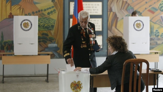 A man casts his ballot during the presidential election at a polling station in Yerevan, February 18, 2013.