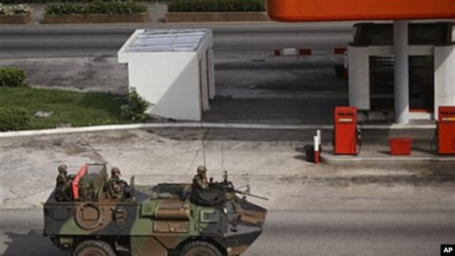 French troops  drive past in a armored car in the city of  Abidjan, Ivory Coast, March 31, 2011