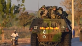 French army soldiers stand on armored vehicles as they leave Bamako and start their deployment to the north of Mali as part of the "Serval" operations, January 15, 2013.