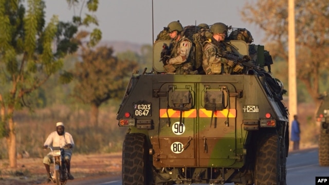 French army soldiers stand on armored vehicles as they leave Bamako and start their deployment to the north of Mali as part of the "Serval" operations, January 15, 2013.