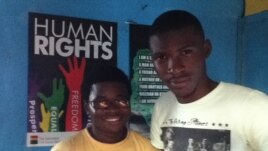 George Freeman (glasses) and co-worker Bernard Wilson at their Freetown office. (VOA - N. deVries)