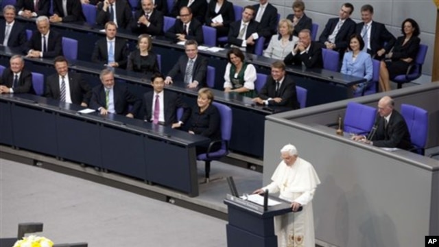German Chancellor Angela Merkel, center left, and her government listen to Pope Benedict XVI, center, as he delivers his speech at the German parliament Bundestag in Berlin, Germany,  Sept. 22, 2011.