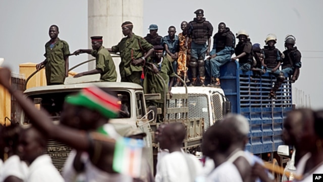 Southern Sudanese security forces watch over an independence rehearsal procession in Juba, South Sudan, July 7, 2011