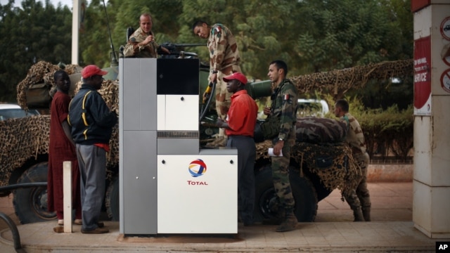 French soldiers fill up their tank at a local petrol station in Sevare, some 620 kilometers (385 miles) north of Mali's capital Bamako,  Jan. 25, 2013. 
