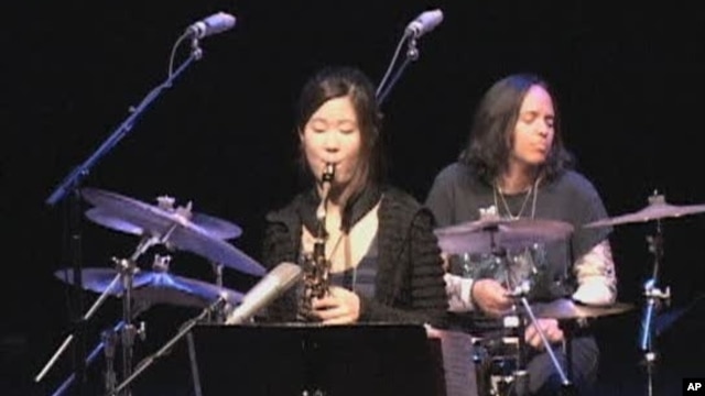 Jazz saxophone player Grace Kelly (center) on stage