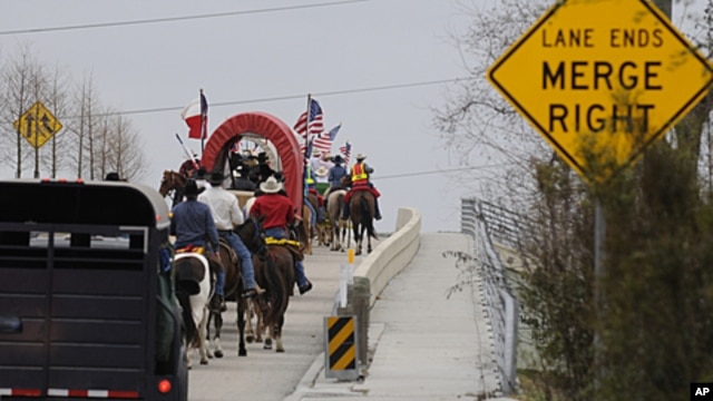 Members of the Valley Lodge Trail Ride make their way up a highway entrance ramp, in Houston to kick-off the Houston Livestock Show and Rodeo, (File February 24, 2011).