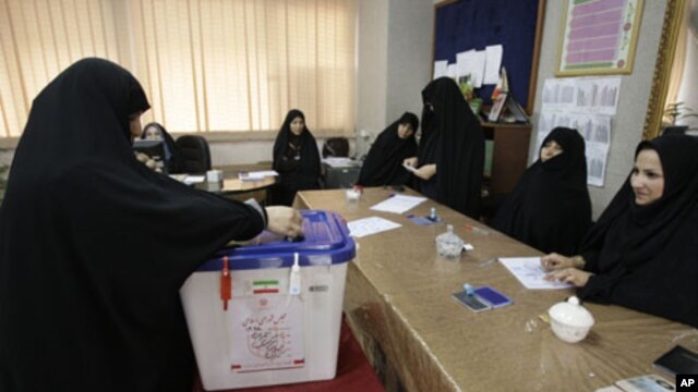An Iranian woman casts her ballot for the parliamentary runoff elections, in a polling station, in Tehran, Iran, May 4, 2012.
