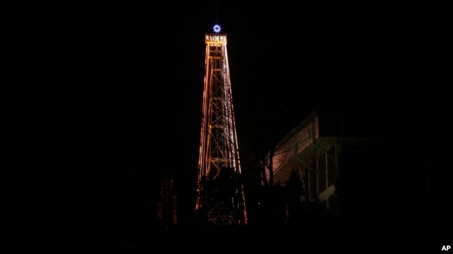 A 30-meter-tall (100-foot-tall) steel Christmas tree with about 30,000 light bulbs, is lit by Christian groups at the western mountain peak, known as Aegibong, in Gimpo, South Korea, December 22, 2012. 