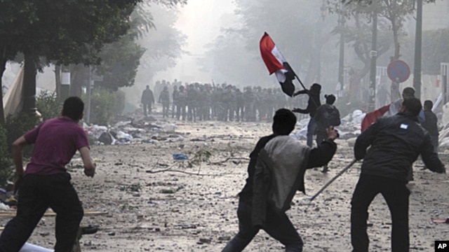 Egyptian protesters throw rocks and firebombs at military police during clashes near Cairo's downtown Tahrir Square, December 16, 2011.