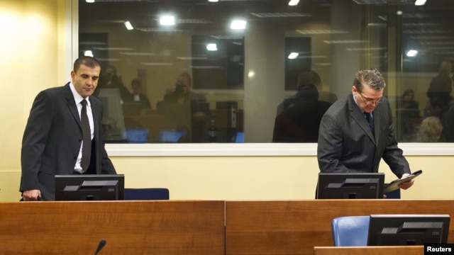 Bosnian Serbs Milan Lukic (L) and Sredoje Lukic (R) sit in the courtroom to attend the appeals verdict in their trial for war crimes in the former Yugoslavia, at the International Criminal Tribunal in The Hague, December 4, 2012.