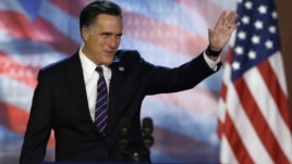 Republican presidential candidate Mitt Romney waves to supporters before conceding at his election night rally, November 7, 2012, in Boston, Massachusetts.
