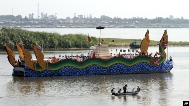 Cambodia's royal family travel by boat to scatter the ashes of Cambodia's former King Norodom Sihanouk near the confluence of the four rivers in Phnom Penh, Tuesday, Feb. 5, 2013, in Phnom Penh Cambodia. In addition some of Sihanouk's ashes will be put in an urn which, according to his wishes, will be placed on the grounds of the Royal Palace near those of his favorite daughter, Kunthea Buppha, who died at the age of 3.