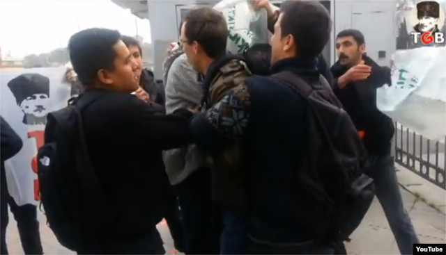 Turkish men are seen placing a plastic bag over the head of a U.S. sailor in Istanbul, Turkey, in a YouTube video, Nov. 12, 2014.