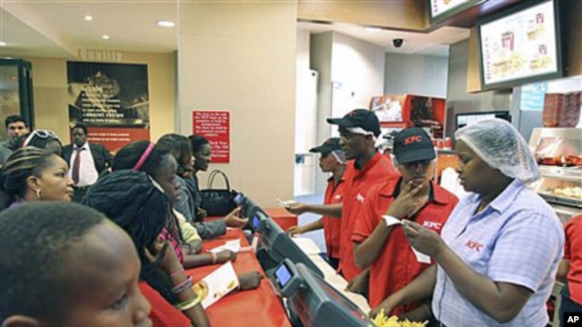 Customers wait to place their orders at a Kentucky Fried Chicken [KFC] restaurant at the Nakumat junction in Nairobi, Kenya, August 23, 2011.