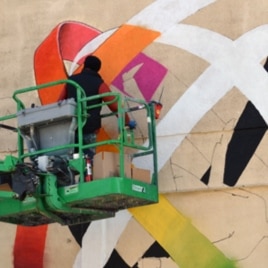 Ukrainian artist Vladimir Manzhos at work on his mural.
