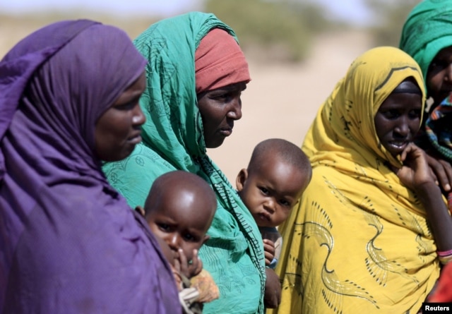 FILE - Women gather at a center while waiting to collect water in the drought stricken Somali region in Ethiopia, Jan. 26, 2016.