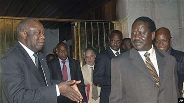 Ivory Coast strongman Laurent Gbagbo, left, talks with Kenyan Prime Minister Raila Odinga, an African Union envoy sent to mediate the ongoing Ivorian political standoff, following a meeting at the presidential palace in Abidjan, Ivory Coast, (January  17,