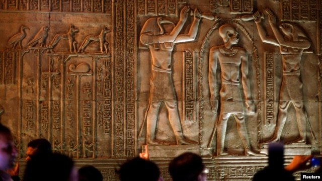 FILE - Tourists examine part of the Kom Ombo Temple, southern Egypt, November 7, 2009. The temple, which dates from about 180 B.C. during the Ptolemaic era stands on the bank of the Nile between Edfu and Aswan.