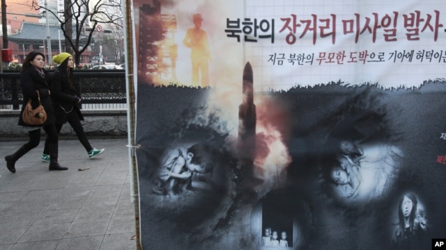 Spanduk memperlihatkan anak-anak Korut  yang kelaparan dan peluncuran roket Korut  terpampang di sebuah jalan di Seoul (foto: dok). Pejabat di Seoul dan Washington mengeluarkan peringatan serius atas uji coba nuklir Korut.