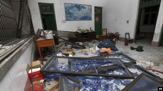 A damaged room in a residential building is seen after several locations were targeted with parcel bombs in the southwestern city of Liucheng, Guangxi province, Sept. 30, 2015.