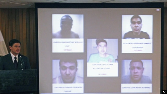 Nuevo Leon State Governor Rodrigo Medina (L) speaks next to photographs of five men believed to be members of the Zetas drug cartel who were arrested in connection with an arson attack at a casino last week that killed 52 people, in Monterrey, Mexico, Aug