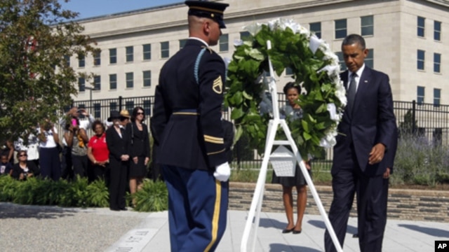 President Barack Obama and first lady Michelle Obama lay a wreath as the 10th anniversary of the Sept. 11 attacks are observed at the Pentagon in Washington, Sunday, Sept. 11, 2011.