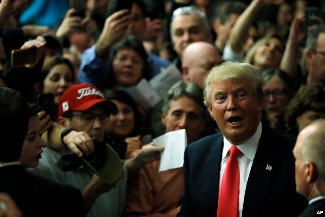 Republican presidential candidate Donald Trump meets with attendees during a campaign stop Feb. 2, 2016, in Milford, N.H.