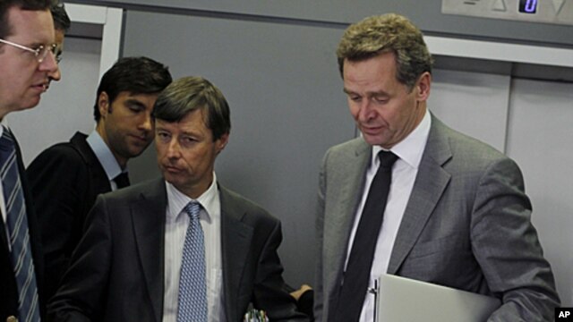 European Commission official Matthias Mors, center, and International Monetary Fund's Paul Thomsen, right, walk after their meeting with Greek Finance Minister Evangelos Venizelos, in central Athens, Sept. 30, 2011.