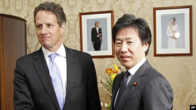 U.S. Treasury Secretary Timothy Geithner, left, shakes hands with his Japanese counterpart Jun Azumi prior to their meeting in Tokyo,  January 12, 2012.