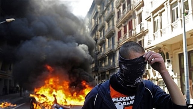 Demonstrator covers face during general strike in Barcelona, Spain, March 29, 2012.