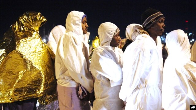 Rescued migrants disembark from an Italian Coast Guard ship in the harbor of Augusta, Sicily, southern Italy, March 4, 2015.