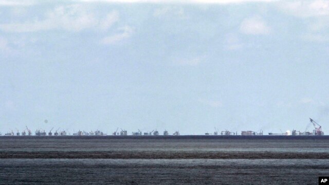 FILE - Ongoing reclamation of Subi Reef by China is seen from Pag-asa Island in the Spratly Islands, South China Sea, western Palawan Province, Philippines, May 2015.