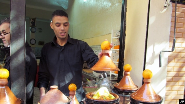 Tagines, or meat and vegetables stews, cook outside a restaurant in the medina of Marrakech.