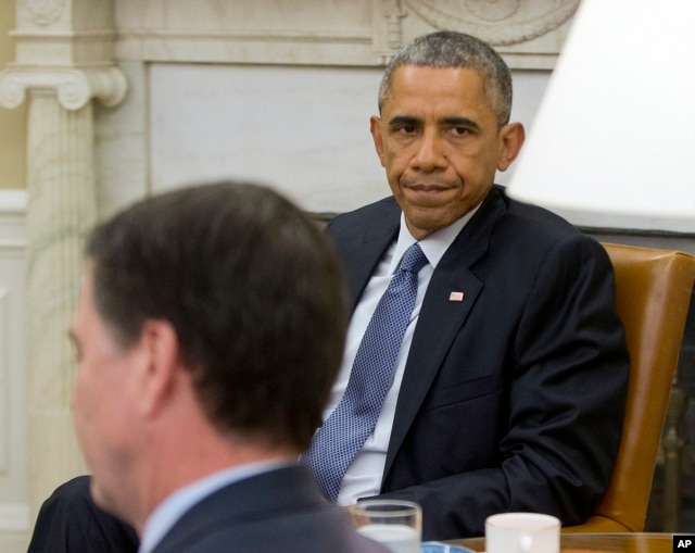 President Barack Obama, right, sits with FBI Director James Comey before speaking to members of the media about the shooting in Chattanooga, Tenn., from the Oval Office of the White House in Washington, July 16, 2015.