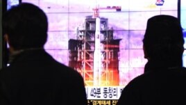 South Koreans watch a TV news reporting launch of the Unha rocket from Tongchang-ri, North Korea, at Seoul Railway Station in Seoul, South Korea, December 12, 2012.