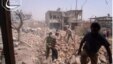 Citizen journalism image provided by Qusair Lens which has been authenticated based on its contents and other AP reporting, shows Syrians inspecting the rubble of damaged buildings due to government airstrikes, in Qusair, Homs province, Syria, May 18, 201