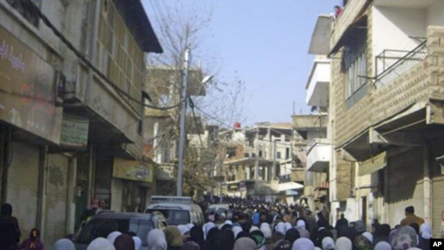 Anti-government protesters attend the funeral of protesters killed in earlier clashes in the Damascus suburb of Zabadani, Syria, December 21, 2011.