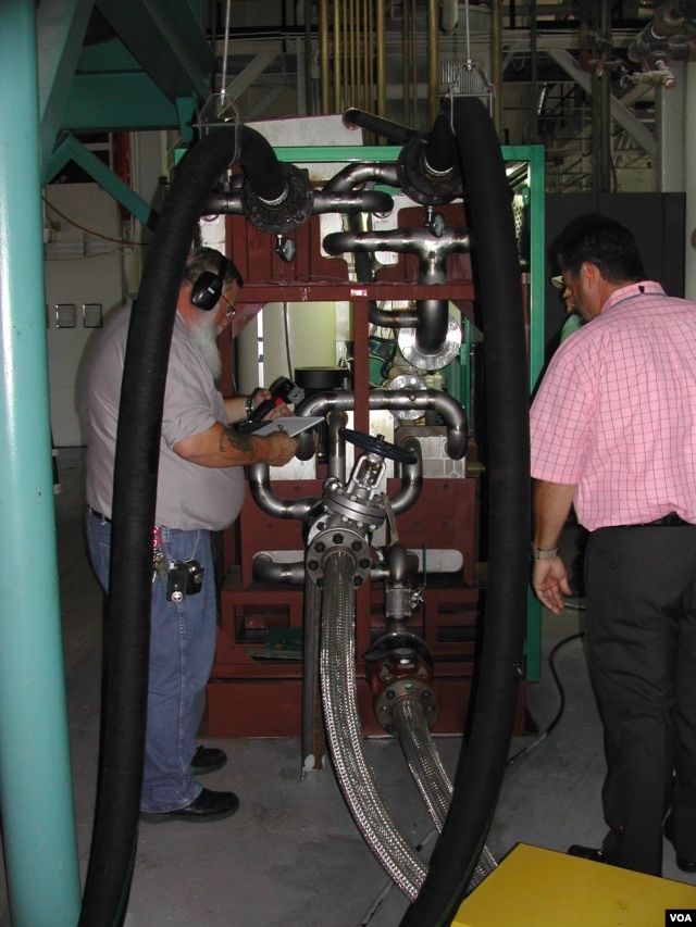 Engineers check the Green Machine, which converts waste heat into electricity, at Southern Methodist University in Dallas. (Courtesy SMU)