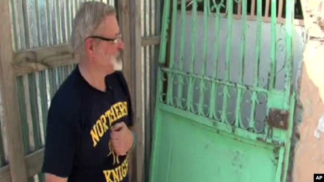 Michael Geilanfeld, who runs St. Joseph's house for former child slaves and street children in Port-au-Prince, shows some of the damage from last year's earthquake.