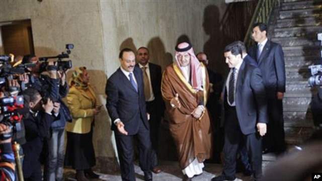 Saudi Arabian Foreign Minister Saud al-Faisal, center, arrives to attend an Arab League's emergency meeting in Cairo, March 12, 2011