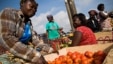 A vendor sorts tomatoes at the Agbogboloshie food market in Accra, Ghana.