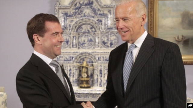 U.S. Vice President Joe Biden (R) shakes hands with Russia's President Dmitry Medvedev during their meeting in the presidential residence at Gorki, outside Moscow March 9, 2011.