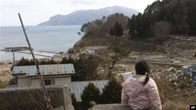 Manami Kon, 4, waits for her parents and younger sister who are still missing after the March 11 massive earthquake and tsunami, in Miyako, northern Japan, March 22, 2011