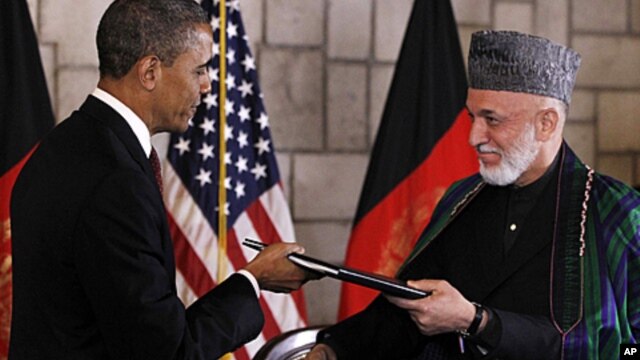President Barack Obama and Afghan President Hamid Karzai sign a strategic partnership agreement at the presidential palace in Kabul, Afghanistan, May 2, 2012.