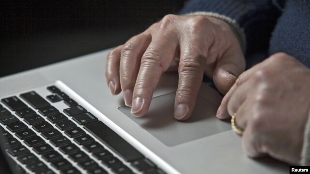 A cyber warfare expert works on his laptop computer in Charlotte, North Carolina, December 1, 2011.