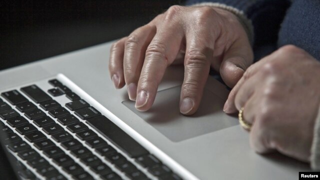A U.S. cyber warfare expert works on his laptop computer, December 1, 2011.