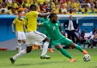 Ivory Coast's Didier Drogba, right, has a shot during the group C World Cup soccer match between Colombia and Ivory Coast at the Estadio Nacional in Brasilia, Brazil, Thursday, June 19, 2014.