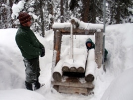 Wildlife biologists John Rohrer and Scott Fitkin check a wolverine trap in Washington’s North Cascades.