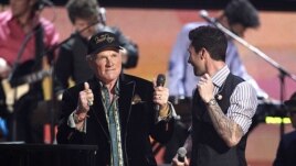 Mike Love of the band Beach Boys and Adam Levine, right, of the band Maroon 5 speak onstage after performing during the 54th annual Grammy Awards in Los Angeles, February 12, 2012. (AP Photo/Matt Sayles)